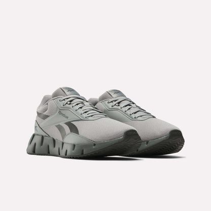 A pair of Reebok Zig Dynamica STR Shoes in light gray with a breathable mesh upper, black side logo, and chunky EVA-cushioned soles, displayed side by side from the front on a plain white background.