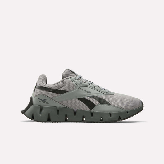 The Reebok Zig Dynamica STR Shoes feature a gray and black mesh upper, EVA cushioning for comfort, a distinctive segmented sole, black side logo, and lace-up closure, shown on a plain white background.