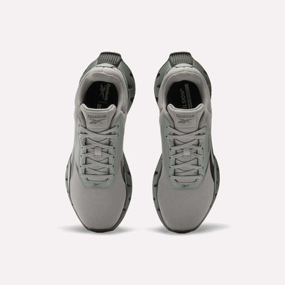 A pair of light gray Reebok Zig Dynamica STR Shoes viewed from above, featuring a mesh upper, lace-up fronts, black outsoles, plush EVA cushioning, and the Reebok logo on the tongue and insole.