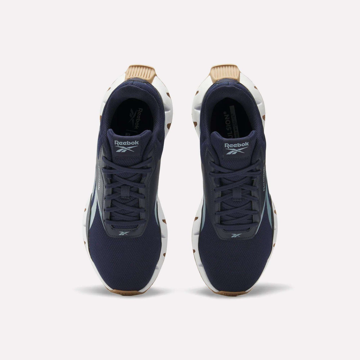 A pair of Reebok Zig Dynamica STR Shoes in dark blue with a breathable mesh upper, white soles, and brown accents, viewed from above on a plain white background.