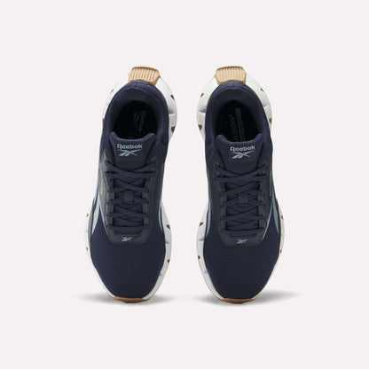 A pair of Reebok Zig Dynamica STR Shoes in dark blue with a breathable mesh upper, white soles, and brown accents, viewed from above on a plain white background.