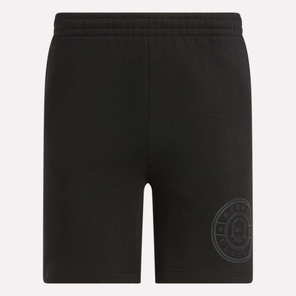 Men's Crest Shorts by Reebok: black relaxed fit cotton shorts for men with an elastic waistband and a subtle Classic logo near the hem. These shorts are plain, with no visible pockets or drawstrings.