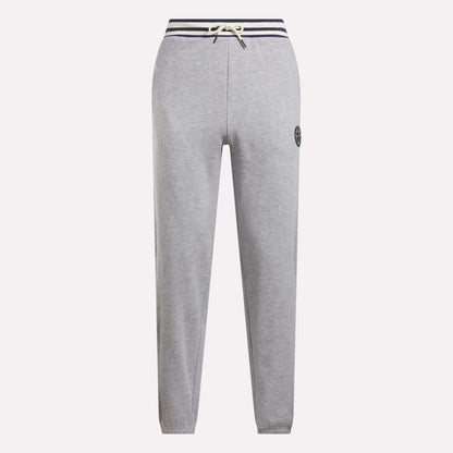 Reebok Men's Lawn Club French Terry Jogger Pants in light gray feature a cotton-blend fabric, navy striped drawstring waistband, straight legs, and a small circular logo on the left thigh. Stylish everyday sporty comfort. Shown on a white background.