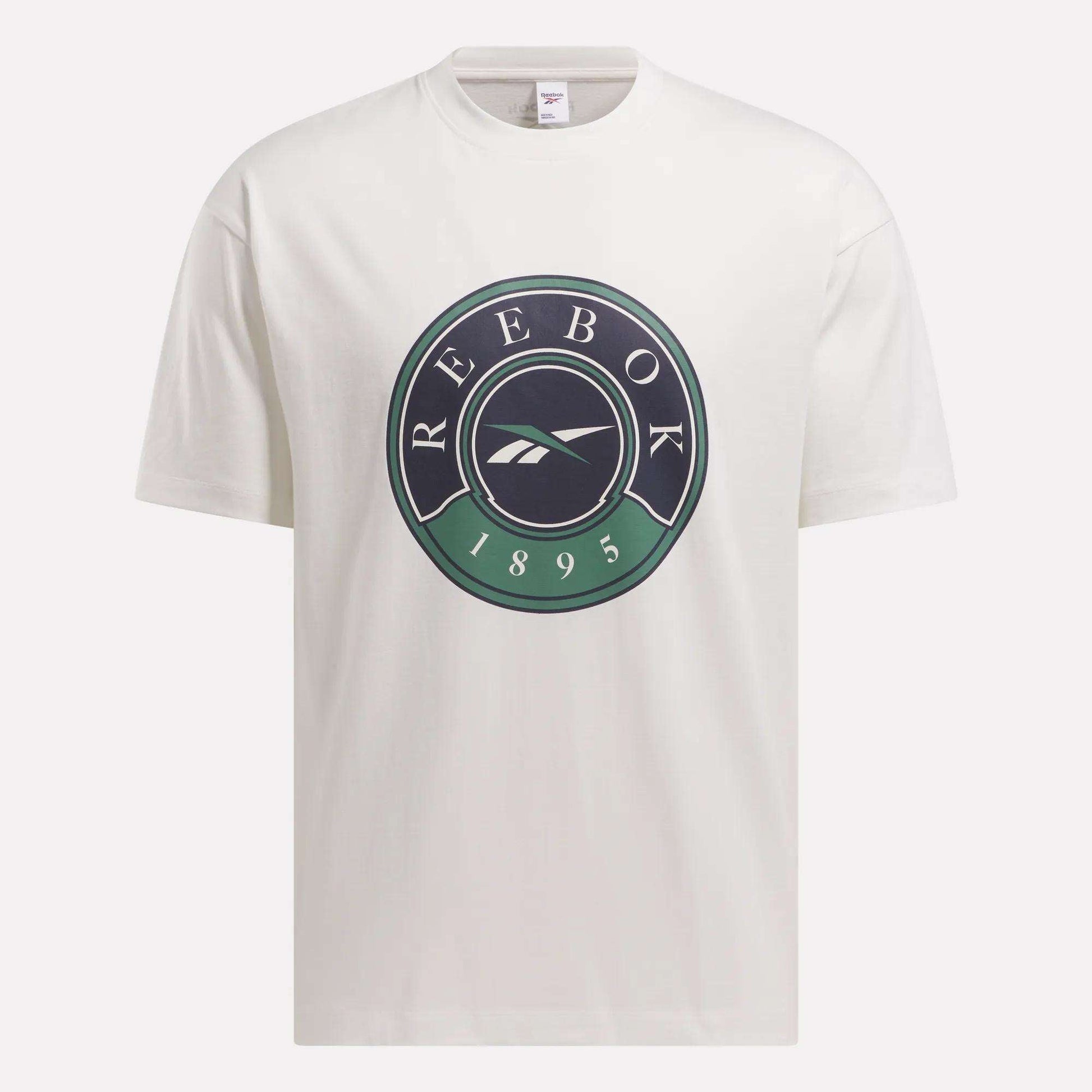 The Men's Lawn Club T-Shirt by Reebok is a white tee with a large circular Lawn Club logo on the chest, displaying "REEBOK," the brand emblem, and "1895" in black and green.