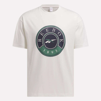 The Men's Lawn Club T-Shirt by Reebok is a white tee with a large circular Lawn Club logo on the chest, displaying "REEBOK," the brand emblem, and "1895" in black and green.