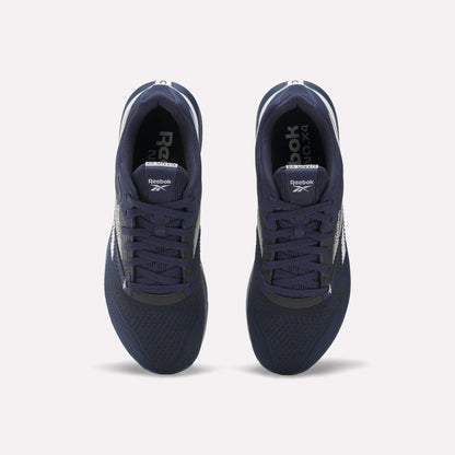 Top view of a pair of Reebok Nano X4 Training Shoes in navy blue, featuring white soles and side logos, crafted with Flexweave material, displayed on a plain light background.