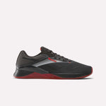 The Reebok Nano X4 Training Shoes feature a black design with red sole and accents, white and silver side stripes, black laces, and a textured upper. These low-cut sneakers are ideal for gym sessions or active wear.