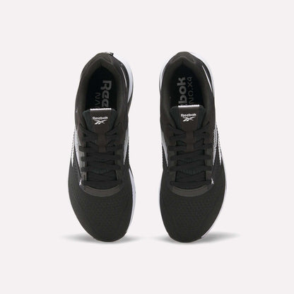 Top view of a pair of black Reebok Nano X4 Training Shoes with white soles and visible Reebok logos on the tongue and inner sole, displayed side by side on a white background.