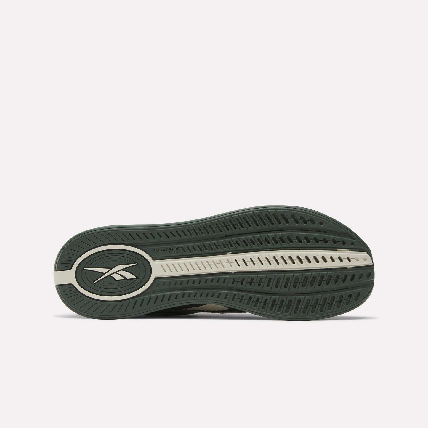 The image shows the green and beige rubber outsole of the Reebok Nano X4 Training Shoes, featuring an oval Reebok logo near the heel, a textured tread for grip, and lightweight Floatride Energy Foam cushioning.