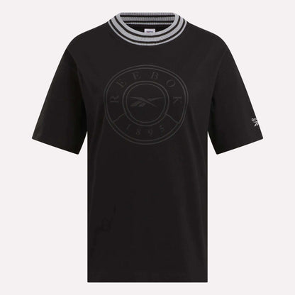 The Women's Lawn Club T-Shirt by Reebok features short sleeves, a black, white, and gray striped round collar, a circular Lawn Club 1895 logo on the front, and a small Reebok logo on the left sleeve—perfect for everyday wear.