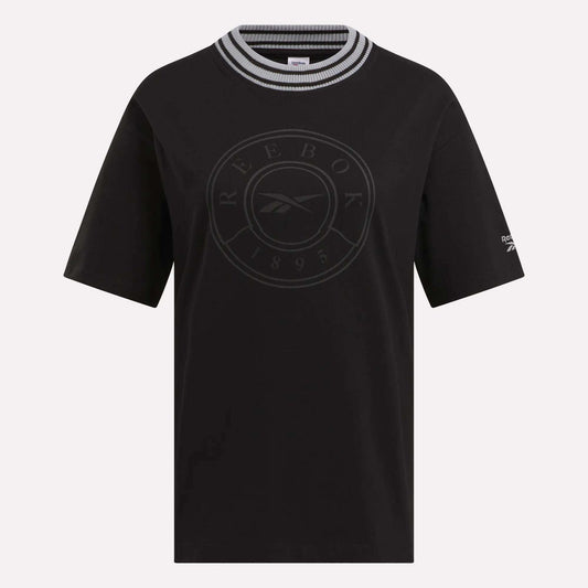 The Women's Lawn Club T-Shirt by Reebok features short sleeves, a black, white, and gray striped round collar, a circular Lawn Club 1895 logo on the front, and a small Reebok logo on the left sleeve—perfect for everyday wear.