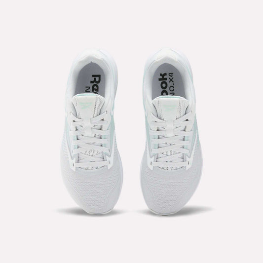 A pair of white Reebok Women's Nano X4 Training Shoes seen from above, featuring breathable mesh uppers, laces, black Reebok branding on the insoles, and Floatride Energy Foam cushioning for comfort.