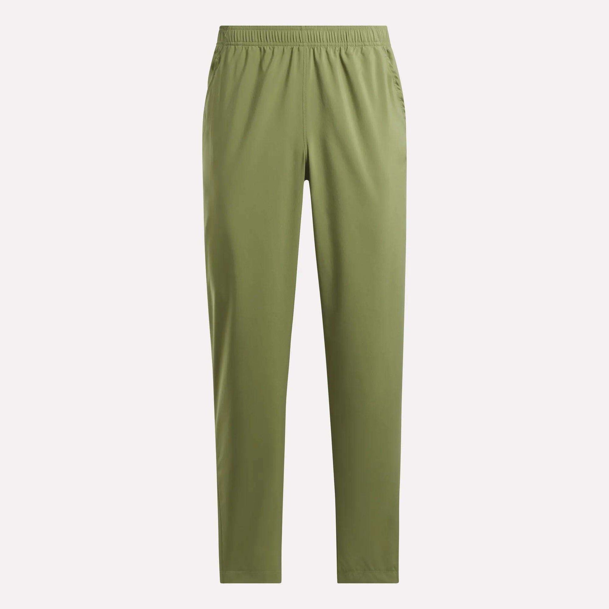 The Reebok Men's Train Woven Unlined Pants are olive green, straight-leg workout pants with an elastic waistband and side pockets, made from lightweight fabric and shown against a plain light background.