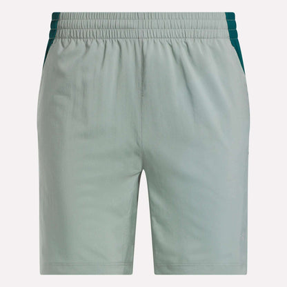Reebok Men's Run Shorts in light green with inner tights, dark green side panels, elastic waistband, and two side pockets. These running shorts feature a simple front design for a sleek look.