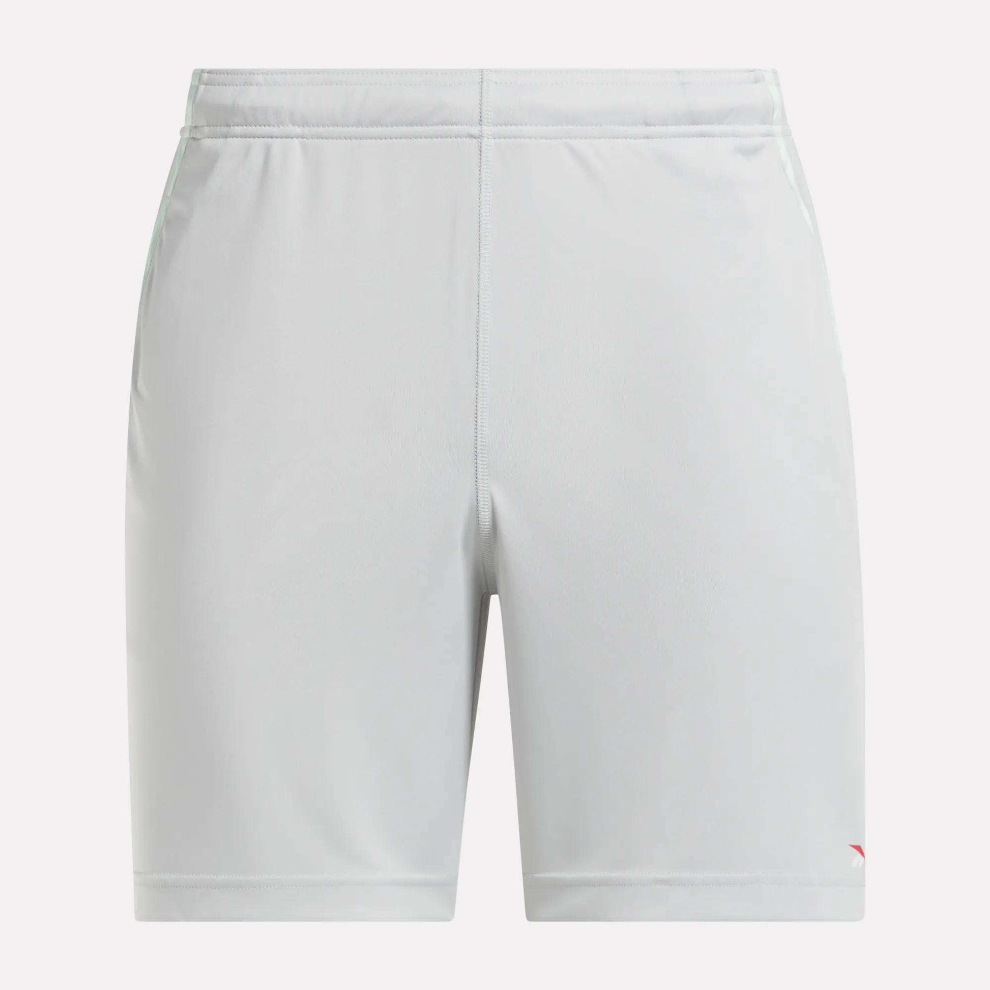 Front view of plain light gray Reebok Men's Train Blocked Knit Shorts featuring an elastic waistband and a small red logo on the lower left leg, ideal for workout enthusiasts.