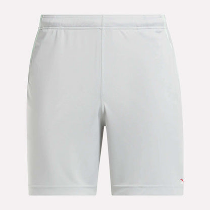 Front view of plain light gray Reebok Men's Train Blocked Knit Shorts featuring an elastic waistband and a small red logo on the lower left leg, ideal for workout enthusiasts.