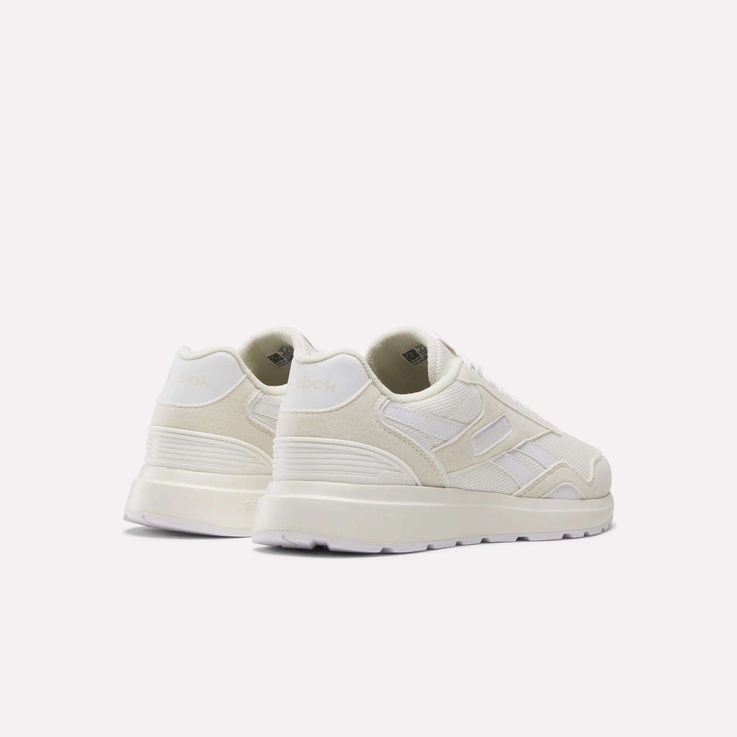 A pair of Reebok Women's GL1100 Shoes in off-white with a retro design, lightweight mesh and suede panels, displayed at an angle to show the back and outer sides against a plain light background.