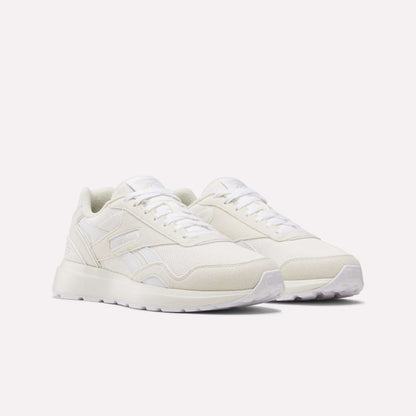 Women's GL1100 Shoes by Reebok, featuring an off-white design with lightweight mesh and suede panels, white laces, and a textured rubber sole, shown on a plain white background.