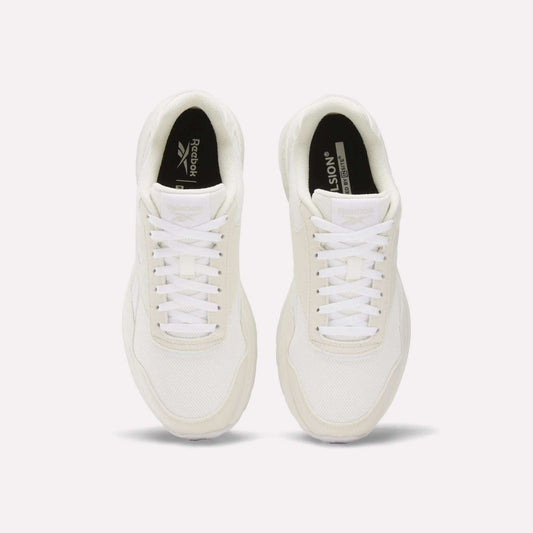A pair of Reebok Women's GL1100 Shoes in white, seen from above, with white laces, mesh texture, and black insoles featuring Reebok branding on a plain white background—ideal for everyday wear.