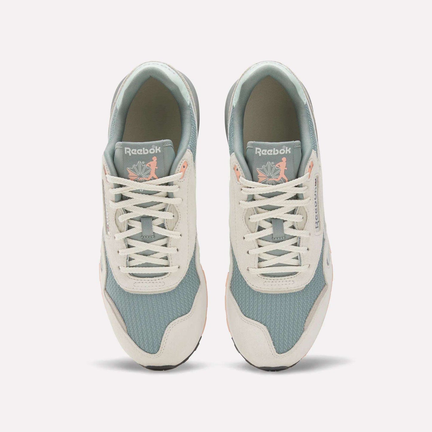 A top view of the Reebok Classic Nylon 89 Shoes shows light blue mesh, off-white suede overlays, and white laces. The cushioned midsole adds comfort, while insoles feature a pink flamingo with leaves for a unique touch.