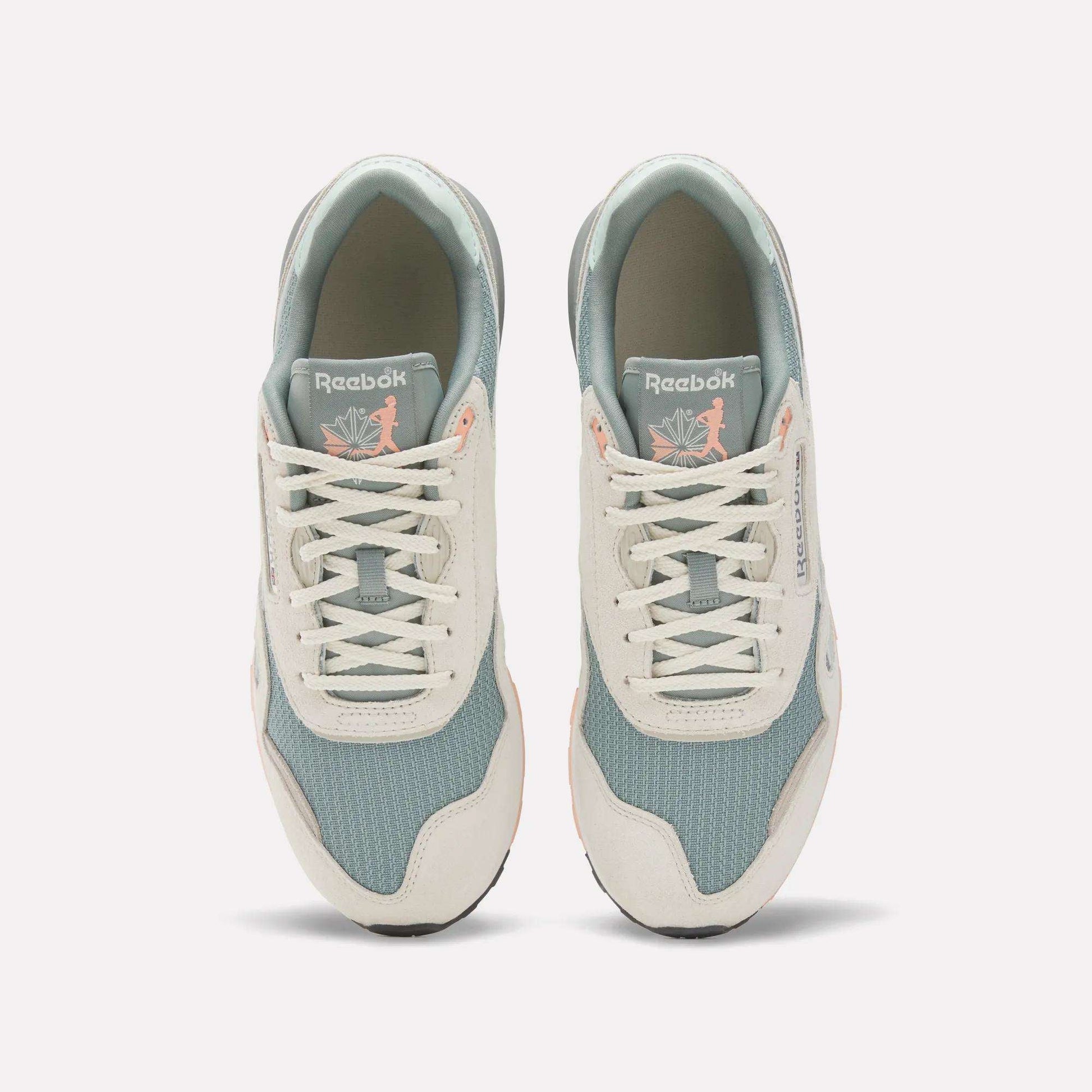 A top view of the Reebok Classic Nylon 89 Shoes shows light blue mesh, off-white suede overlays, and white laces. The cushioned midsole adds comfort, while insoles feature a pink flamingo with leaves for a unique touch.