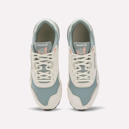 A top view of the Reebok Classic Nylon 89 Shoes shows light blue mesh, off-white suede overlays, and white laces. The cushioned midsole adds comfort, while insoles feature a pink flamingo with leaves for a unique touch.