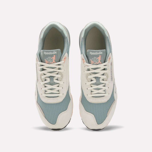 A top view of the Reebok Classic Nylon 89 Shoes shows light blue mesh, off-white suede overlays, and white laces. The cushioned midsole adds comfort, while insoles feature a pink flamingo with leaves for a unique touch.