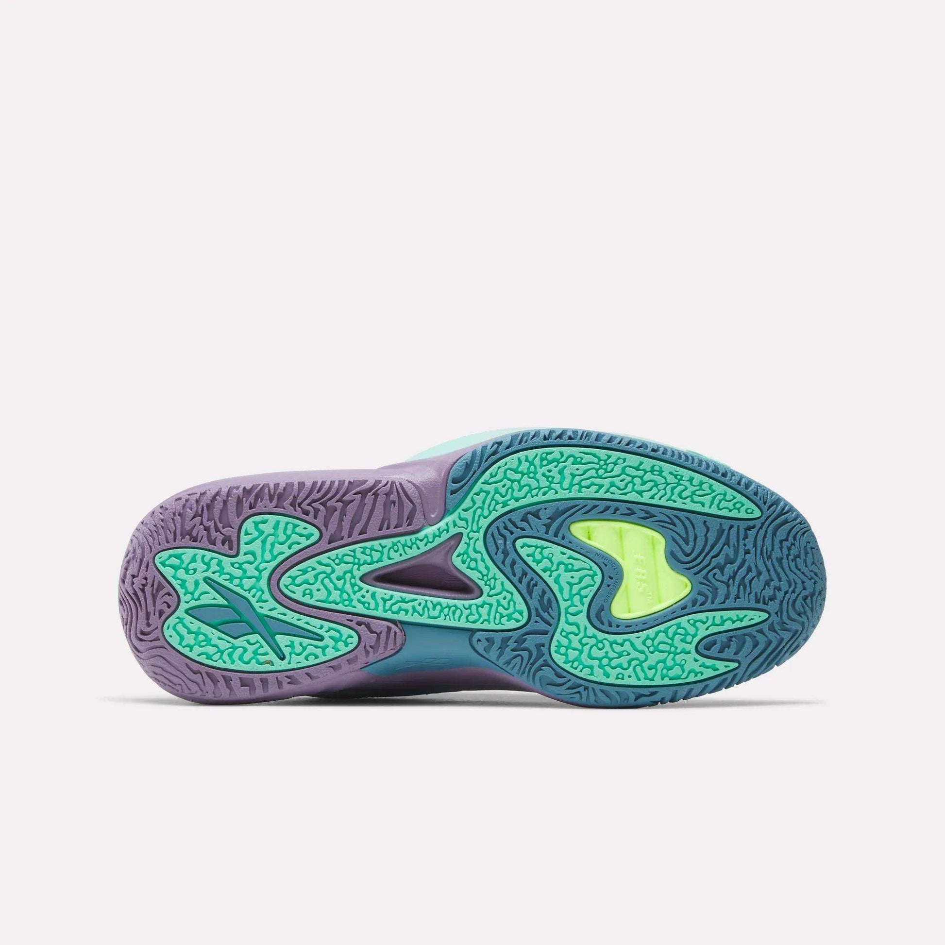 The image shows the colorful sole of the Reebok Engine A 26 Basketball Shoes, with a mix of teal, green, purple, and yellow hues and textured wavy tread patterns for stability, set against a plain white background.