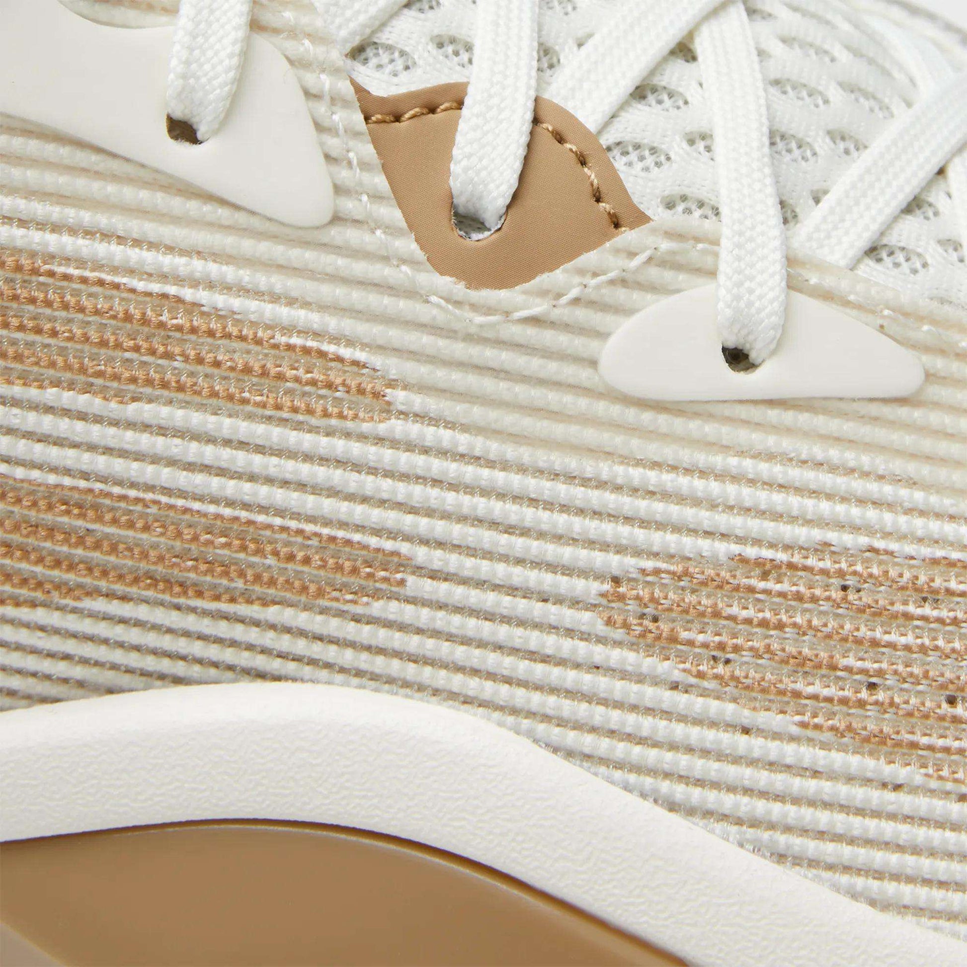 Close-up of the Reebok Engine A 26 Basketball Shoes, showcasing cream and beige striped fabric, white laces, beige and white eyelets, a tan accent near the laces, and textured details inspired by classic basketball shoes.