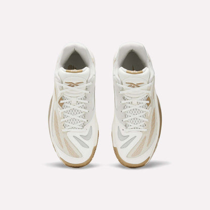 Top view of Reebok Engine A 26 Basketball Shoes: white athletic sneakers with beige and gray accents, mesh and synthetic details, white laces for stability and energy return, plus light brown rubber soles on a plain white background.