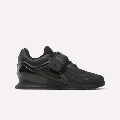 The Reebok Women's Legacy Lifter IV Training Shoes feature a thick sole, mesh upper, and wide midfoot strap, offering support and stability for weightlifting.