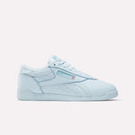 The Women's Freestyle Lo Shoes by Reebok, shown in light blue with a low-top lace-up design and side branding, are ideal for everyday wear and displayed on a plain white background.