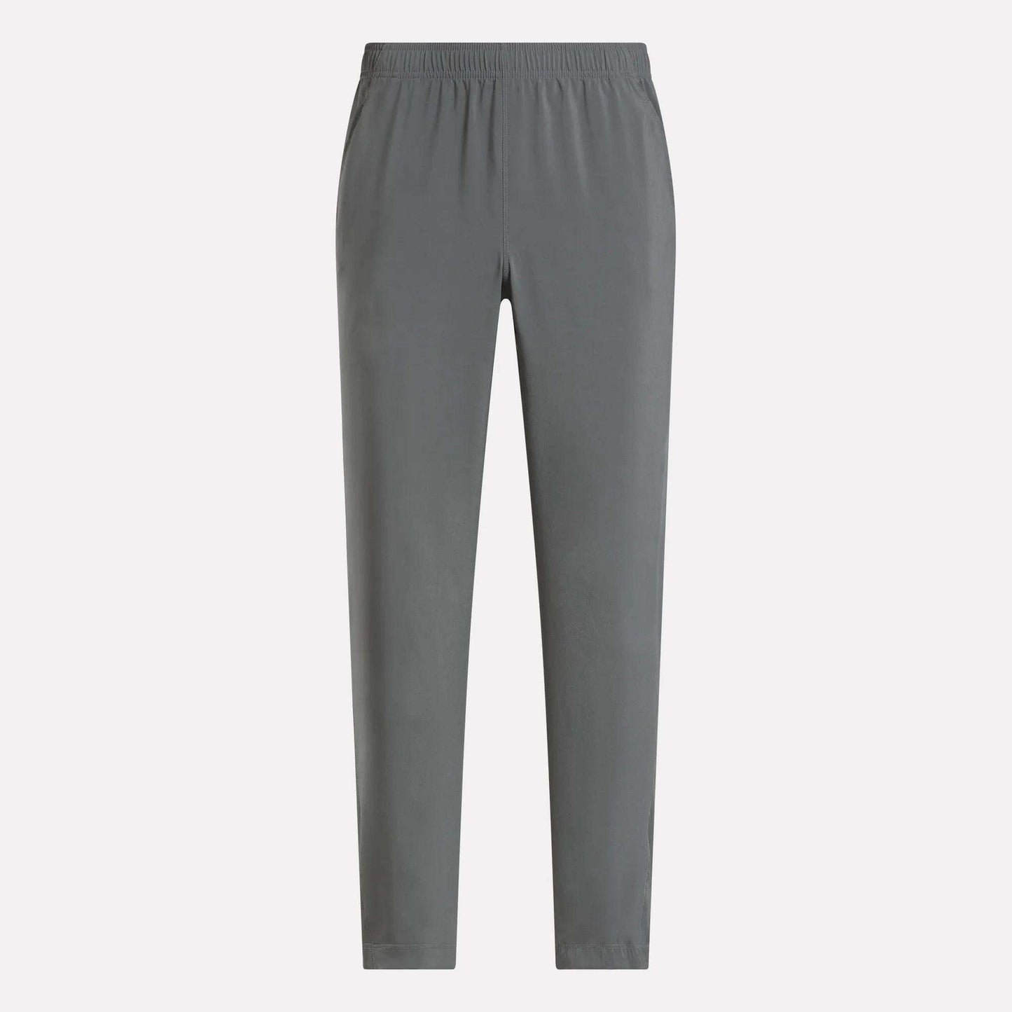 The Reebok Men's Train Woven Unlined Pants in plain gray feature an elastic waistband and are perfect as lightweight workout pants for the gym or everyday comfort, shown here against a light background.