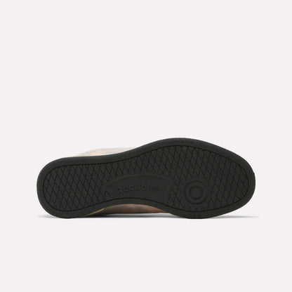 The image shows the black rubber sole of Reebok x MARKET Club C 85 Shoes, featuring a diamond-patterned tread and central Reebok branding. The sneaker lies on its side with the sole facing up.