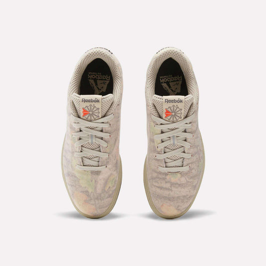 Top view of Reebok x MARKET Club C 85 Shoes in beige, featuring subtle pastel patterns, white laces, black insoles with the Reebok logo, and a red logo patch on each tongue. Court-inspired style with unique MARKET detailing.