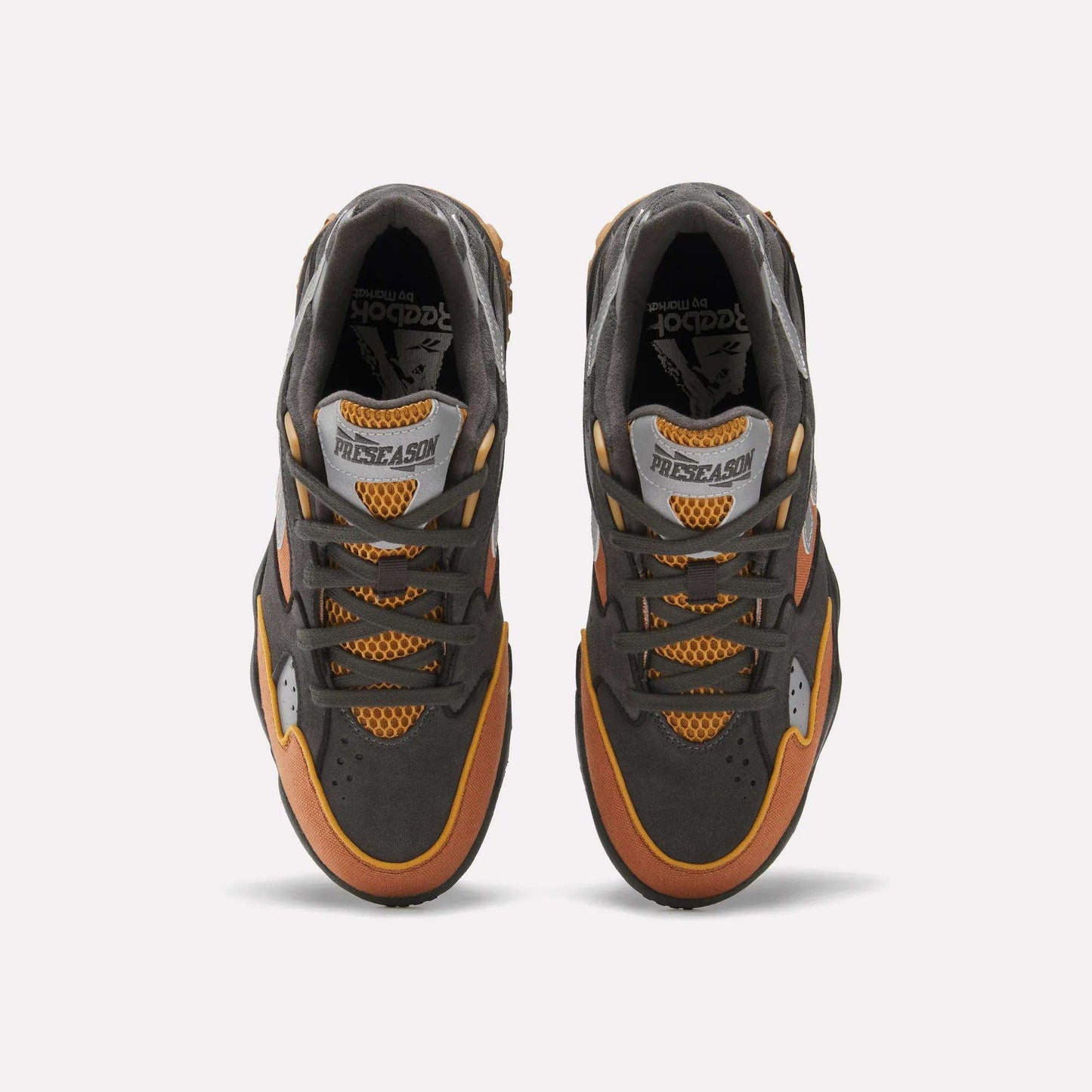 Top view of Reebok x MARKET Preseason 94 Low Shoes in dark gray, orange, and yellow, featuring mesh details and “PRESEASON” on the tongue, shown against a plain white background.