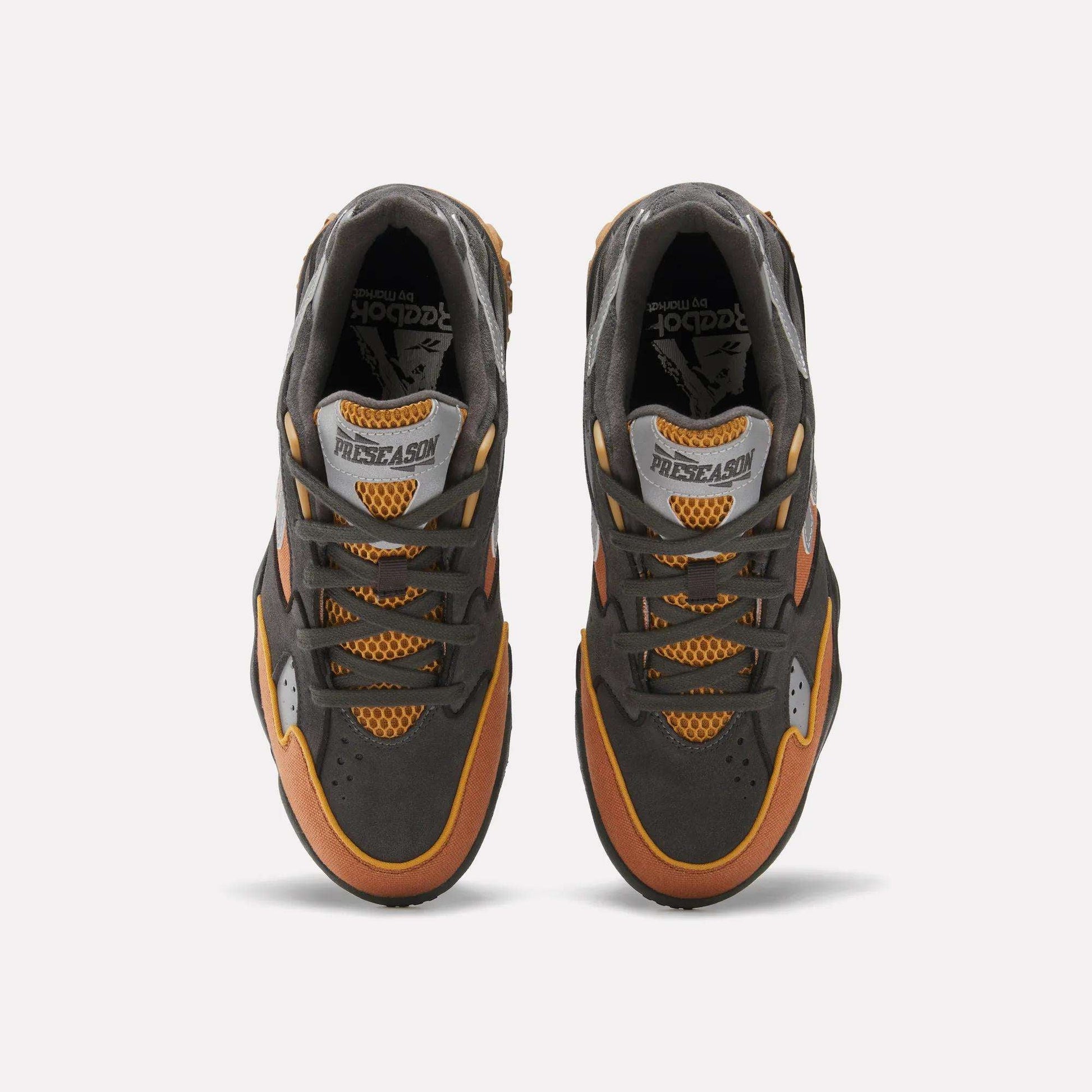 Top view of Reebok x MARKET Preseason 94 Low Shoes in dark gray, orange, and yellow, featuring mesh details and “PRESEASON” on the tongue, shown against a plain white background.