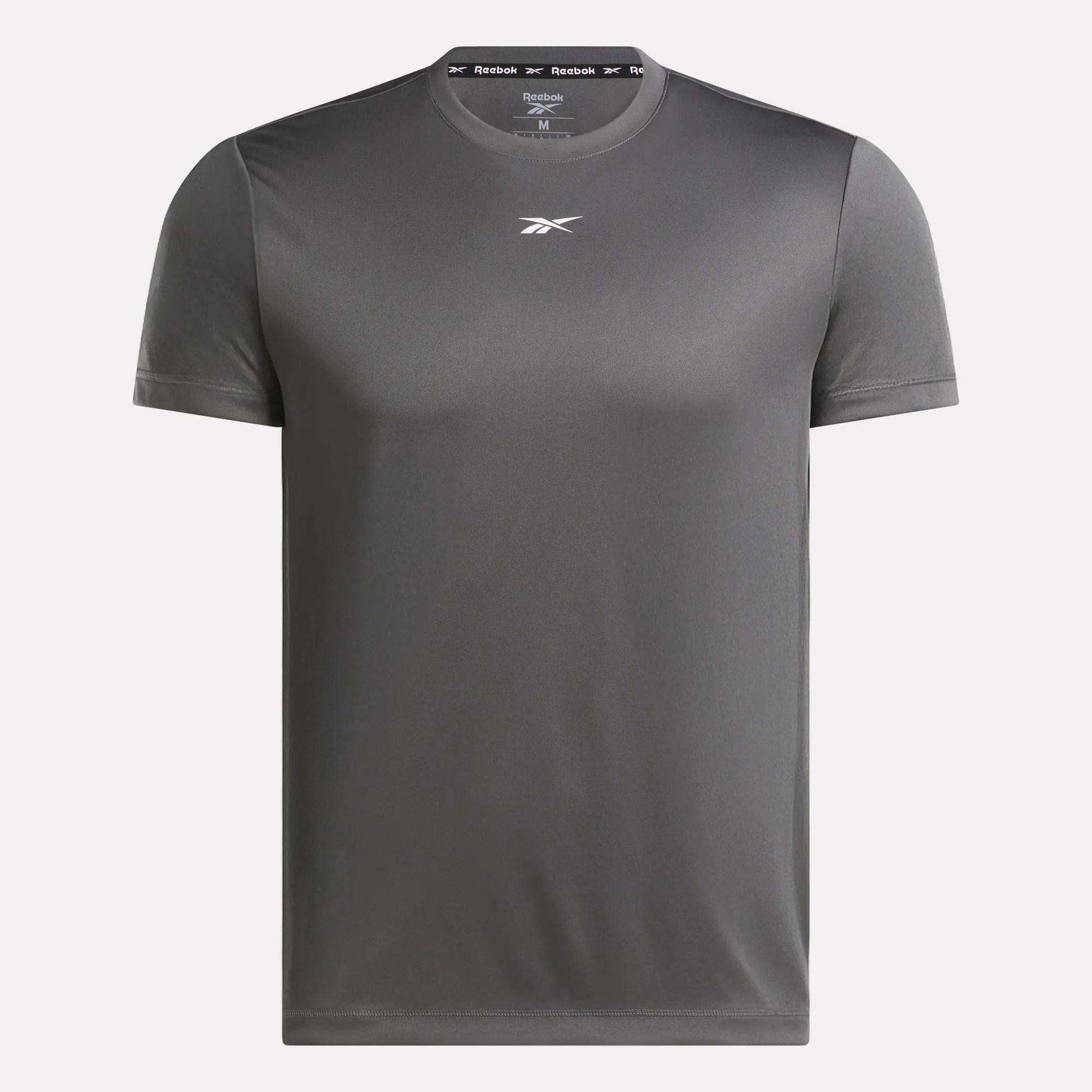 The Reebok Men's Short Sleeve Tech Training T-Shirt is a dark gray, sweat-wicking gym shirt with a crew neck, short sleeves, and a small white logo on the chest. It features a plain design ideal for athletic training.