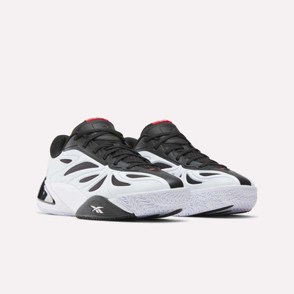 The Reebok Angel Reese 1 Basketball Shoes feature a wavy, futuristic black and white design with a chunky sole, red tongue accents, and Energy Return System for high performance. Shown on a white background.
