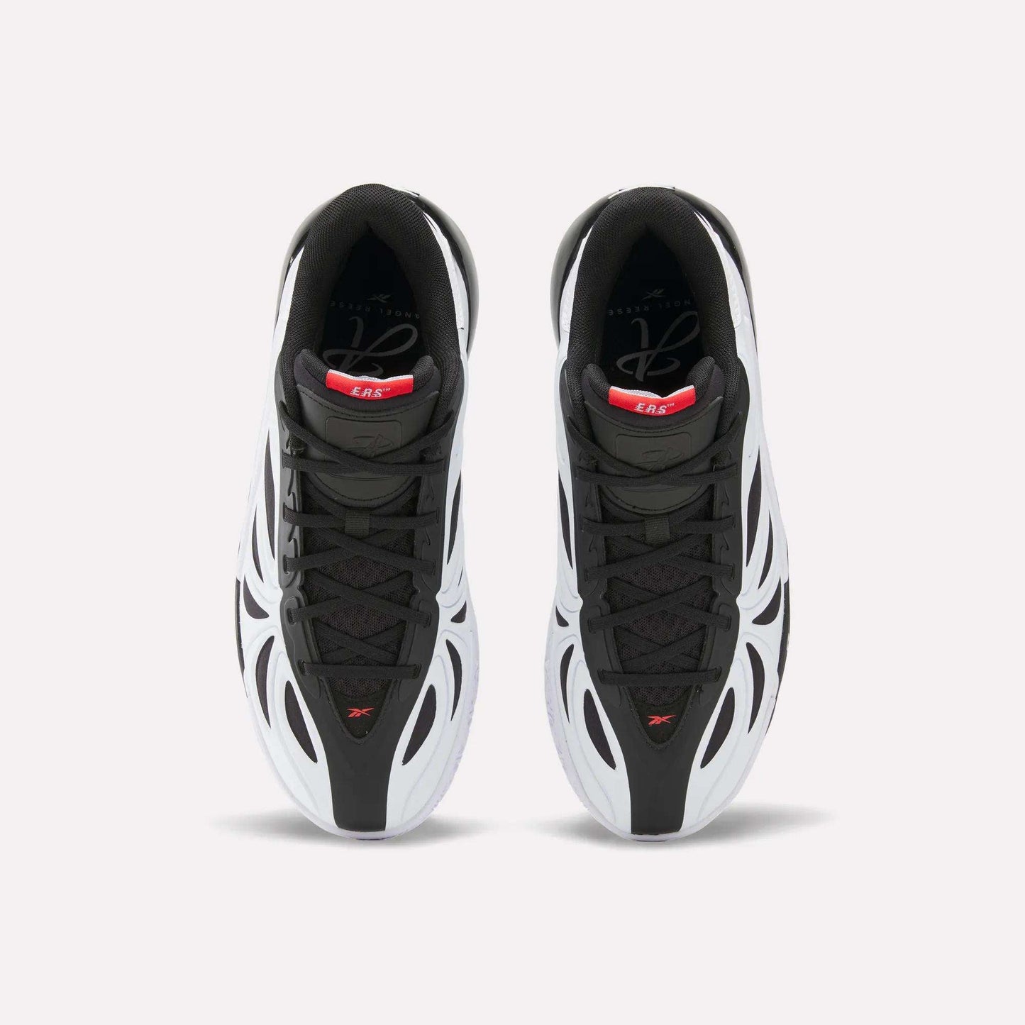 Top view of black, white, and red Reebok Angel Reese 1 Basketball Shoes with the Energy Return System, wavy futuristic design, and black laces. These performance sneakers are displayed side by side on a plain light background.