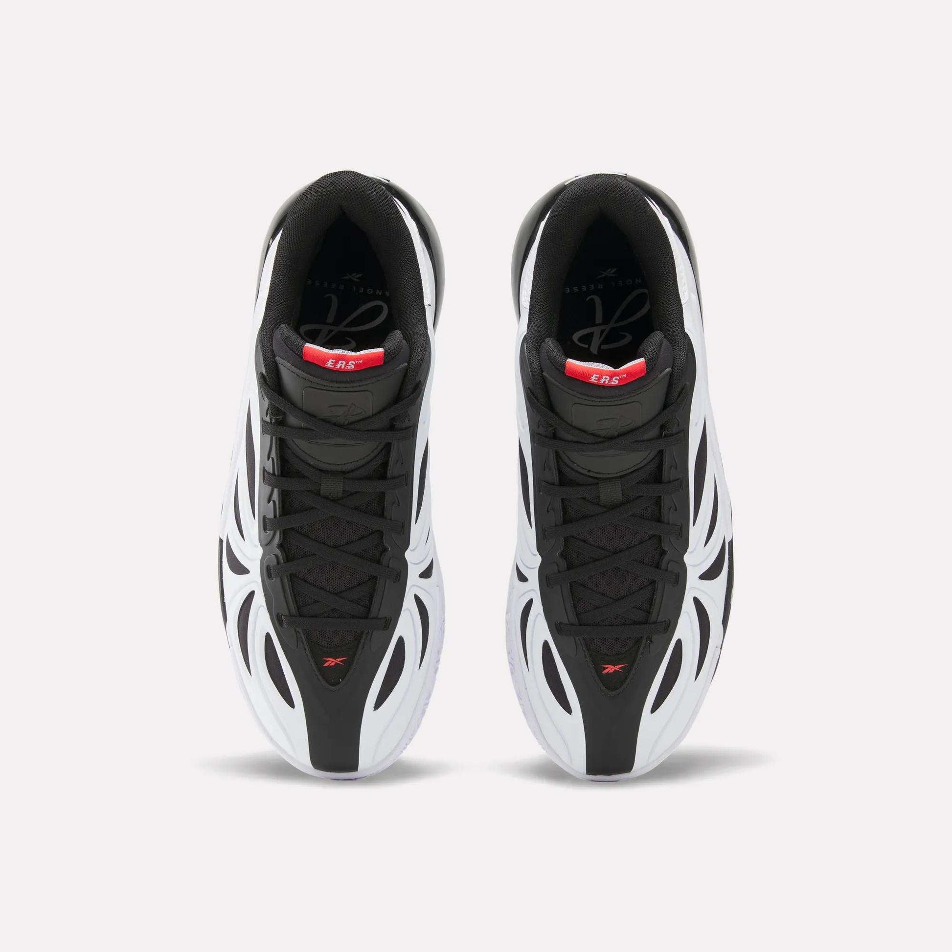 Top view of black, white, and red Reebok Angel Reese 1 Basketball Shoes with the Energy Return System, wavy futuristic design, and black laces. These performance sneakers are displayed side by side on a plain light background.