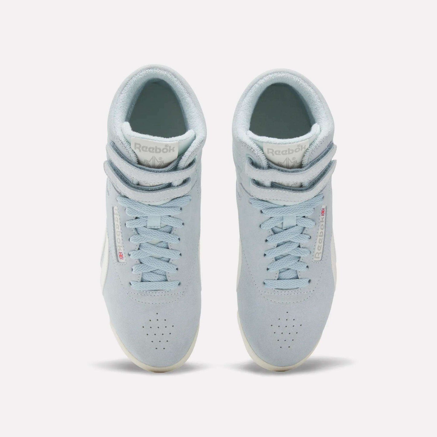 The Reebok Women's F/S Hi Shoes are light blue high top sneakers with suede uppers, white soles, perforated toes, and double Velcro straps at the top, shown from an overhead angle.