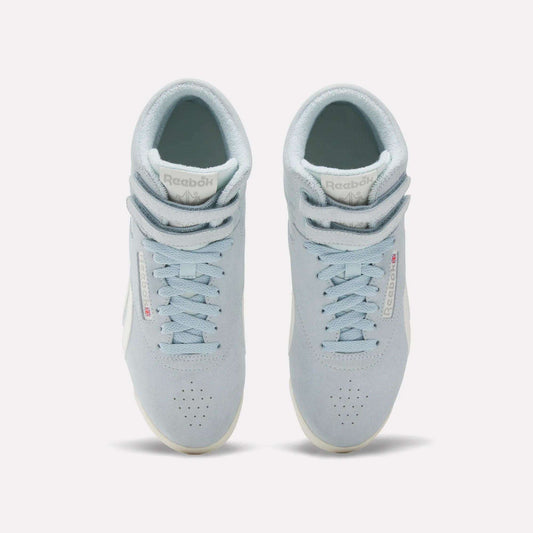 The Reebok Women's F/S Hi Shoes are light blue high top sneakers with suede uppers, white soles, perforated toes, and double Velcro straps at the top, shown from an overhead angle.