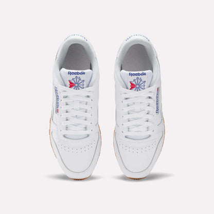 A pair of Reebok Classic Leather Shoes in white, seen from above, with white laces, a gum sole, and the iconic blue and red logo—these retro Reebok sneakers deliver timeless style.