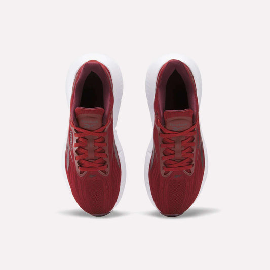 Top view of Reebok Women's Zignition Running Shoes with red mesh uppers and white soles, side by side on a light background. These cushioned running shoes are laced up and ready for action.