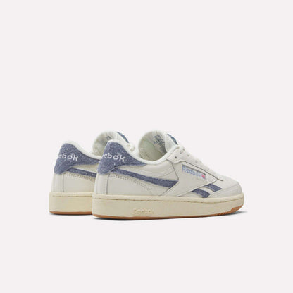 A pair of Reebok Women's Club C Revenge Shoes in white with blue suede accents, shown from the back and side on a plain light background.
