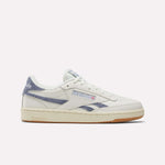 The Reebok Women's Club C Revenge Shoes feature a white design with blue accents, beige sole, and Reebok logos on the side and heel, shown in side profile against a plain white background—ideal for fans of classic women's court shoes.