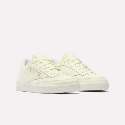 A pair of Women's Club C Revenge Shoes by Reebok in pale yellow, showcasing vintage court style with white soles, side Reebok branding, and matching laces, displayed against a plain white background.