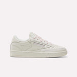 A side view of the Reebok Women's Club C 85 Vintage Shoes in white with light pink laces and accents, featuring classic leather for a subtle retro style, set against a plain white background.
