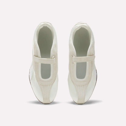 The Reebok Women's Ultra Lo Mary Jane Shoes are white slip-ons with beige accents and a wide elastic top strap, shown from above on a plain white background.